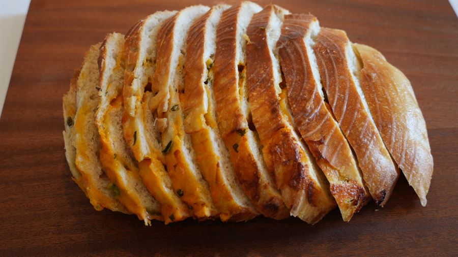 A sliced jalapeño cheddar sourdough loaf
