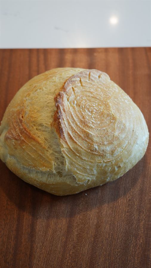 A scored, golden plain sourdough boule